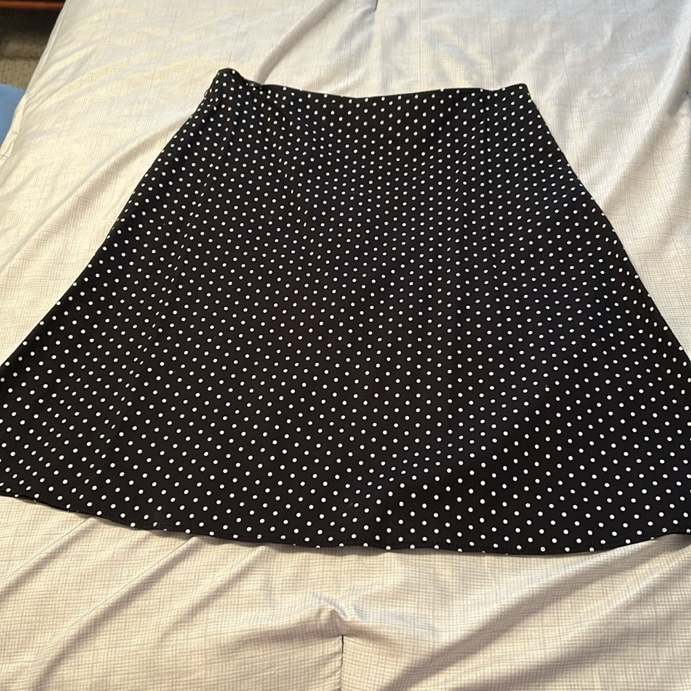 Black and white polkadot skirt a line.